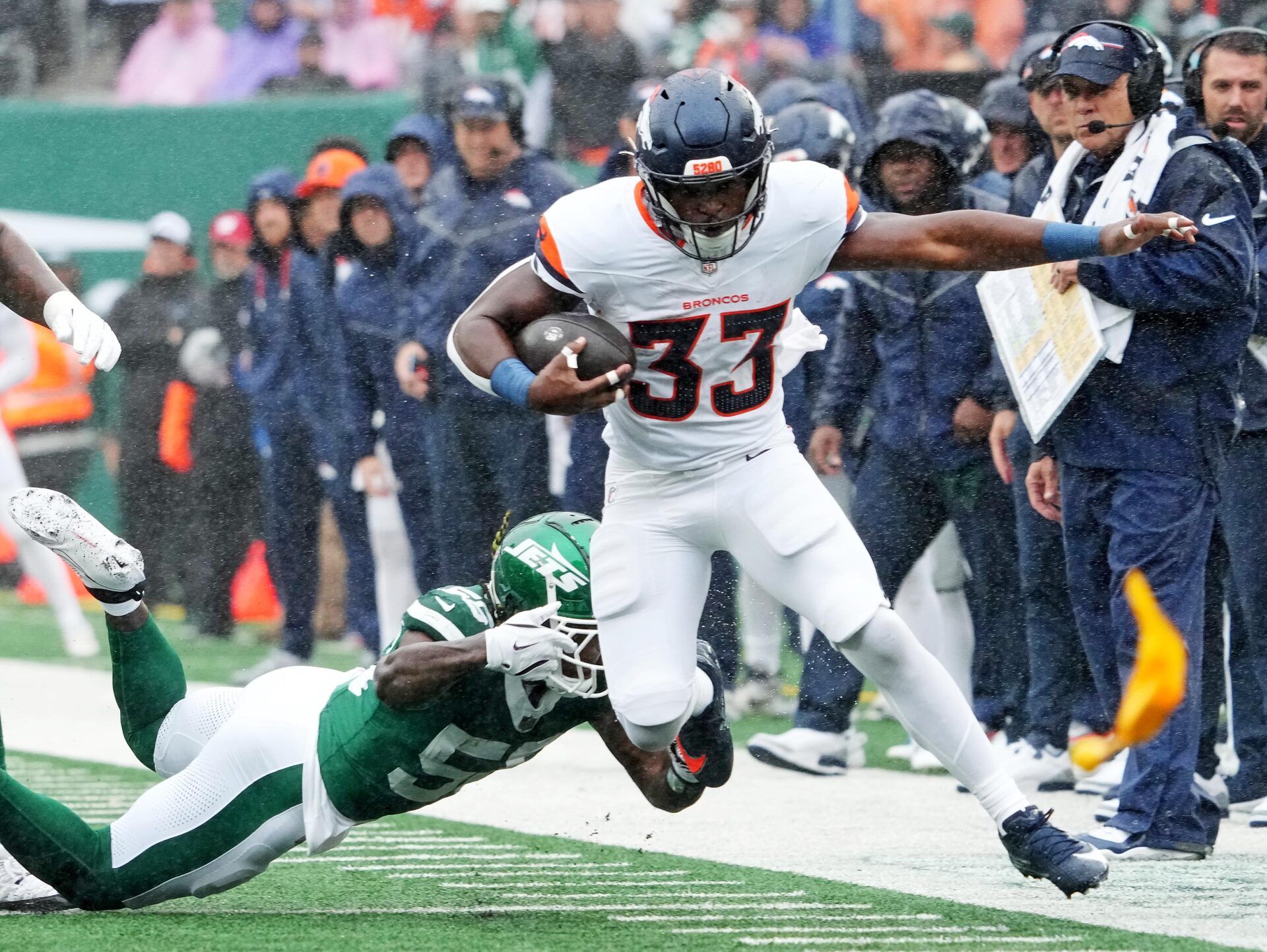 Denver Broncos running back Javonte Williams (33) runs the ball against New York Jets linebacker Quincy Williams (56) during the first quarter at MetLife Stadium.