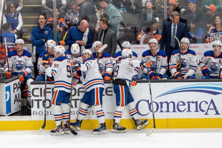 Edmonton Oilers right wing Kasperi Kapanen (42) and Edmonton Oilers right wing Corey Perry (90) and teammates celebrate the open net goal against the San Jose Sharks during the third period at SAP Center at San Jose.