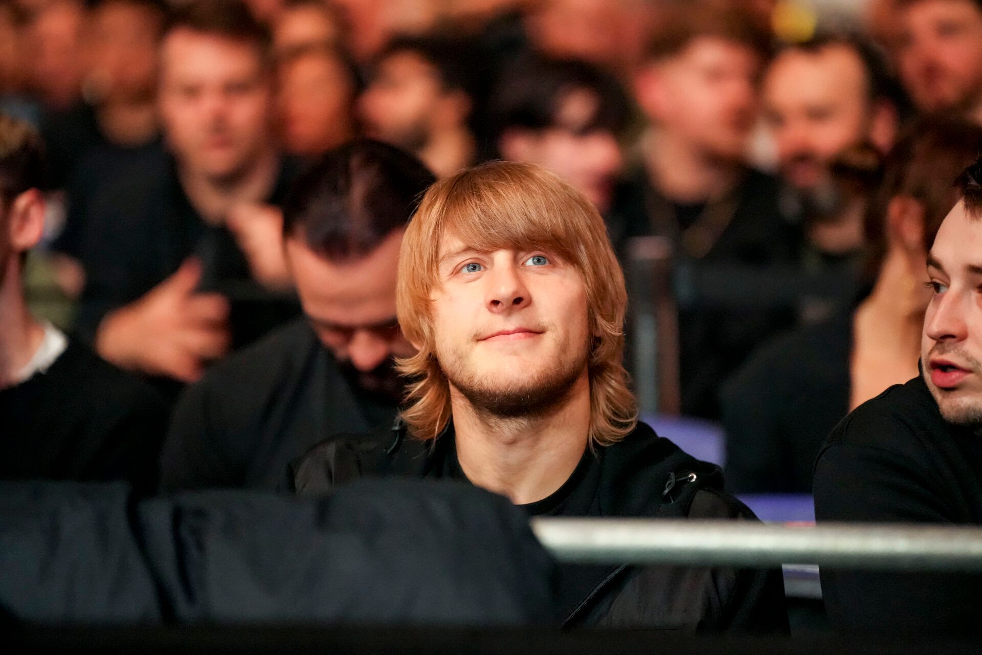Mar 22, 2025; London, England, United Kingdom; Paddy Pimblett, UFC Lightweight fighter, watches as Jai Herbert (red gloves) fights against Chris Padilla (blue gloves) during UFC Fight Night at O2 Arena. Mandatory Credit: Peter van den Berg-Imagn Images