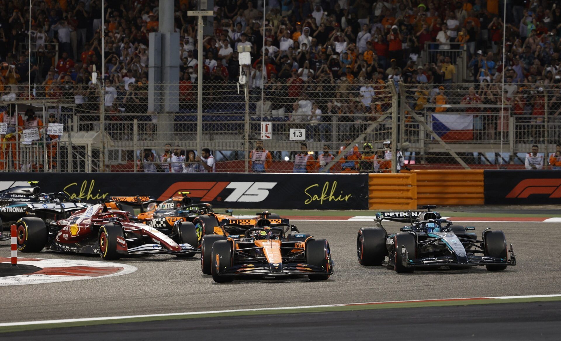 Sakhir, BAHRAIN; Oscar Piastri leads George Russell into the first corner at the start of the race during the F1 Bahrain Grand Prix at the Bahrain International Circuit.