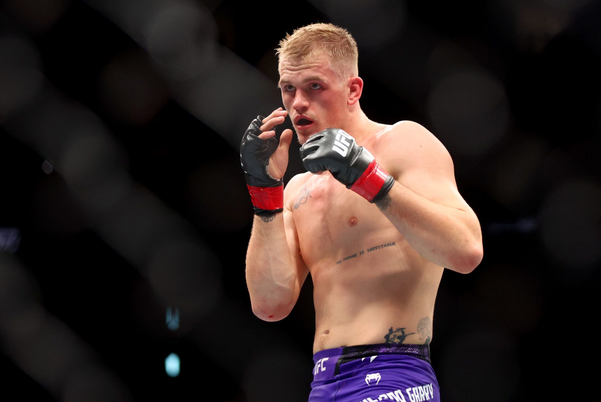 Jun 29, 2024; Las Vegas, Nevada, USA; Ian Machado Garry (red gloves) fights Michael Page (not pictured) during UFC 303 at T-Mobile Arena. Mandatory Credit: Mark J. Rebilas-USA TODAY Sports