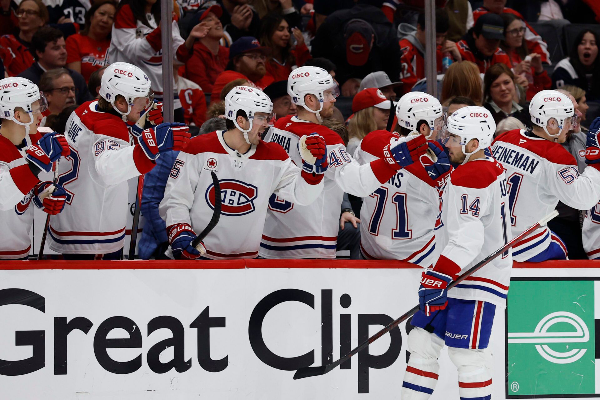 Apr 21, 2025; Washington, District of Columbia, USA; Montreal Canadiens center Nick Suzuki (14) celebrates with teammates after scoring a goal against the Washington Capitals in the third period in game one of the first round of the 2025 Stanley Cup Playoffs at Capital One Arena. Mandatory Credit: Geoff Burke-Imagn Images