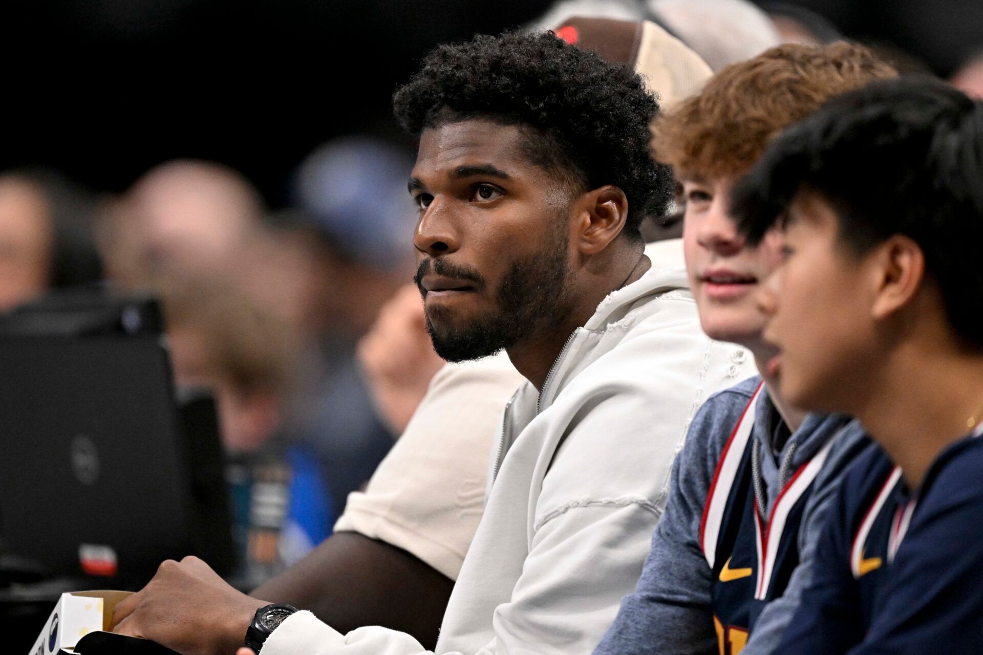 Jan 14, 2025; Dallas, Texas, USA; Colorado Buffaloes quarterback Shedeur Sanders watches the game between the Dallas Mavericks and the Denver Nuggets during the second quarter at the American Airlines Center. Mandatory Credit: Jerome Miron-Imagn Images