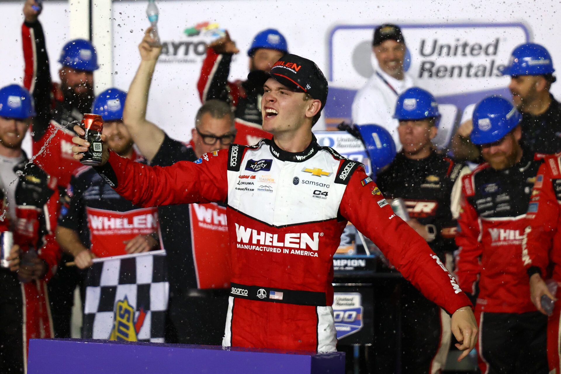 Feb 15, 2025; Daytona Beach, Florida, USA; Xfinity Series driver Jesse Love (2) reacts in victory lane after winning the United Rentals 300 at Daytona International Speedway. Mandatory Credit: Peter Casey-Imagn Images