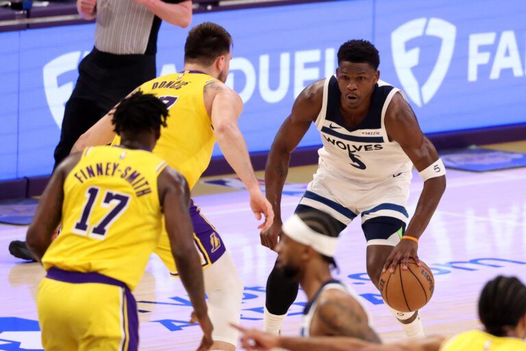 Apr 22, 2025; Los Angeles, California, USA; Minnesota Timberwolves guard Anthony Edwards (5) dribbles the ball against Los Angeles Lakers guard Luka Doncic (77) during the first quarter of game two of first round for the 2024 NBA Playoffs at Crypto.com Arena. Mandatory Credit: Kiyoshi Mio-Imagn Images