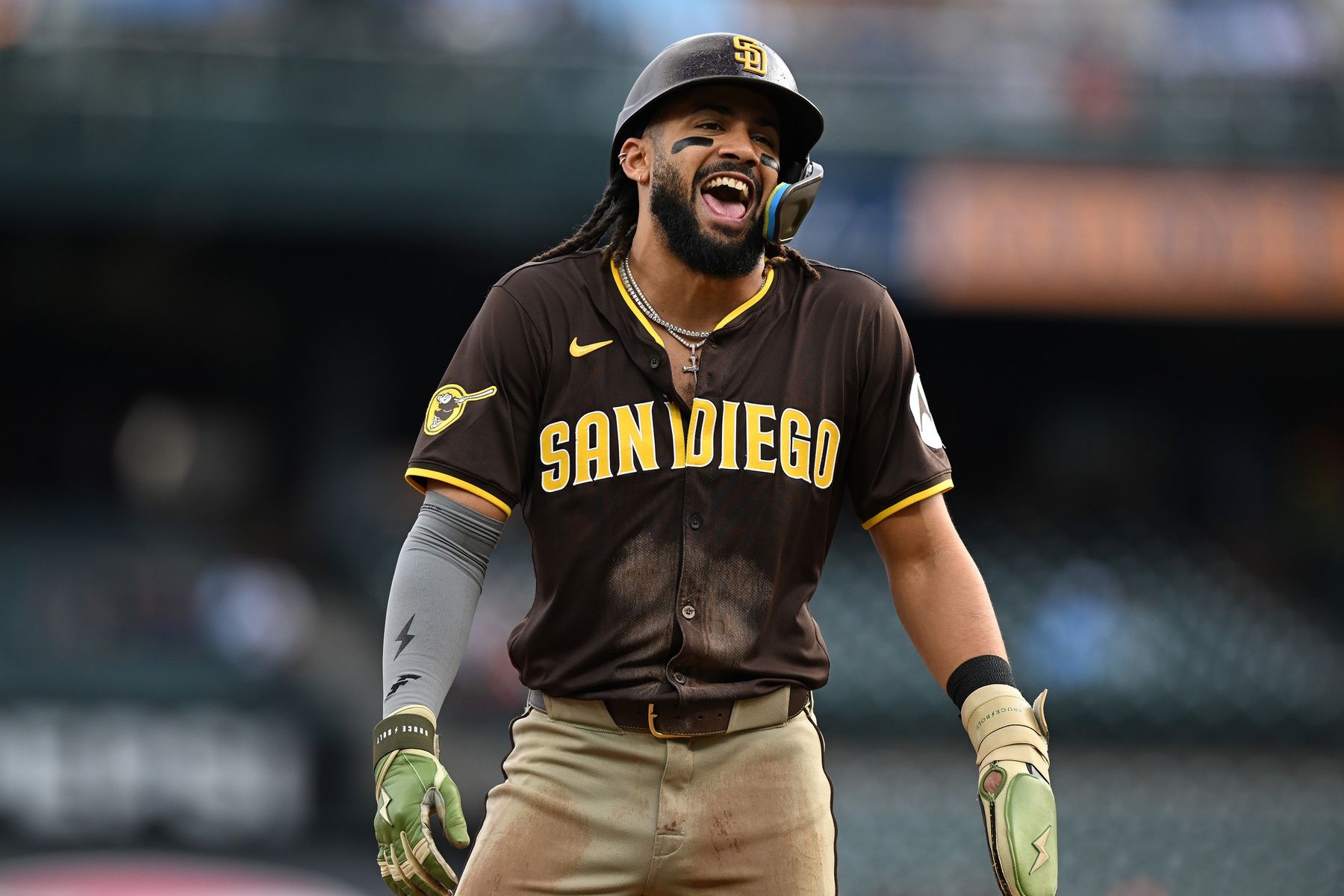 Apr 21, 2025; Detroit, Michigan, USA; San Diego Padres right fielder Fernando Tatis Jr. (23) jokes with the players in the Detroit Tigers dugout while standing on third base in the first inning at Comerica Park. Mandatory Credit: Lon Horwedel-Imagn Images