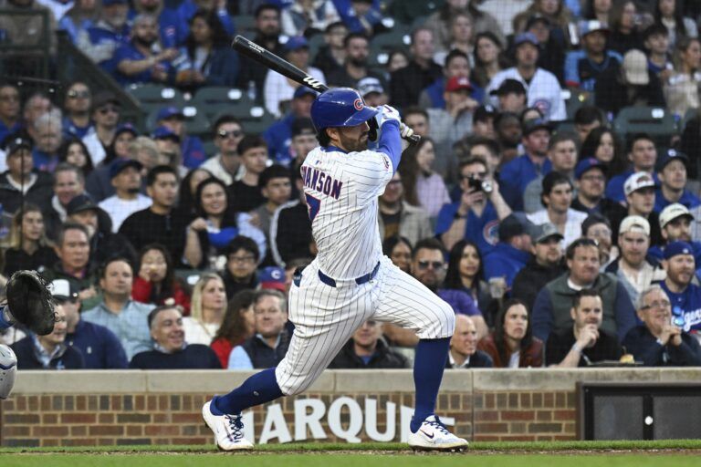 Chicago Cubs shortstop Dansby Swanson (7) singles during the fourth inning against the Los Angeles Dodgers at Wrigley Field.