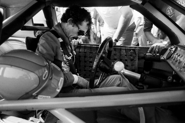 Driver Richard Petty buckles in during qualifying trials for the Nashville Pepsi 420 NASCAR Grand National race at Nashville International Raceway on July 13, 1984. Petty will start in the third spot for the race.