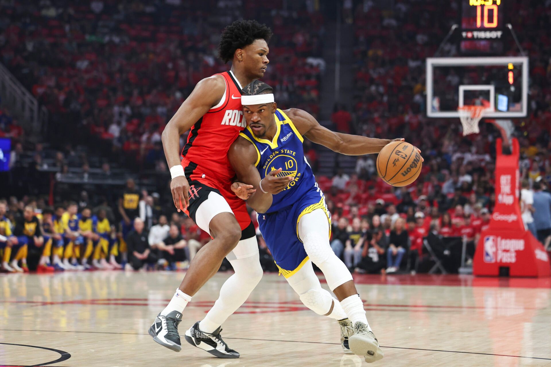 Apr 20, 2025; Houston, Texas, USA; Golden State Warriors forward Jimmy Butler III (10) dribbles the ball as Houston Rockets forward Amen Thompson (1) defends during the first quarter at Toyota Center. Mandatory Credit: Troy Taormina-Imagn Images