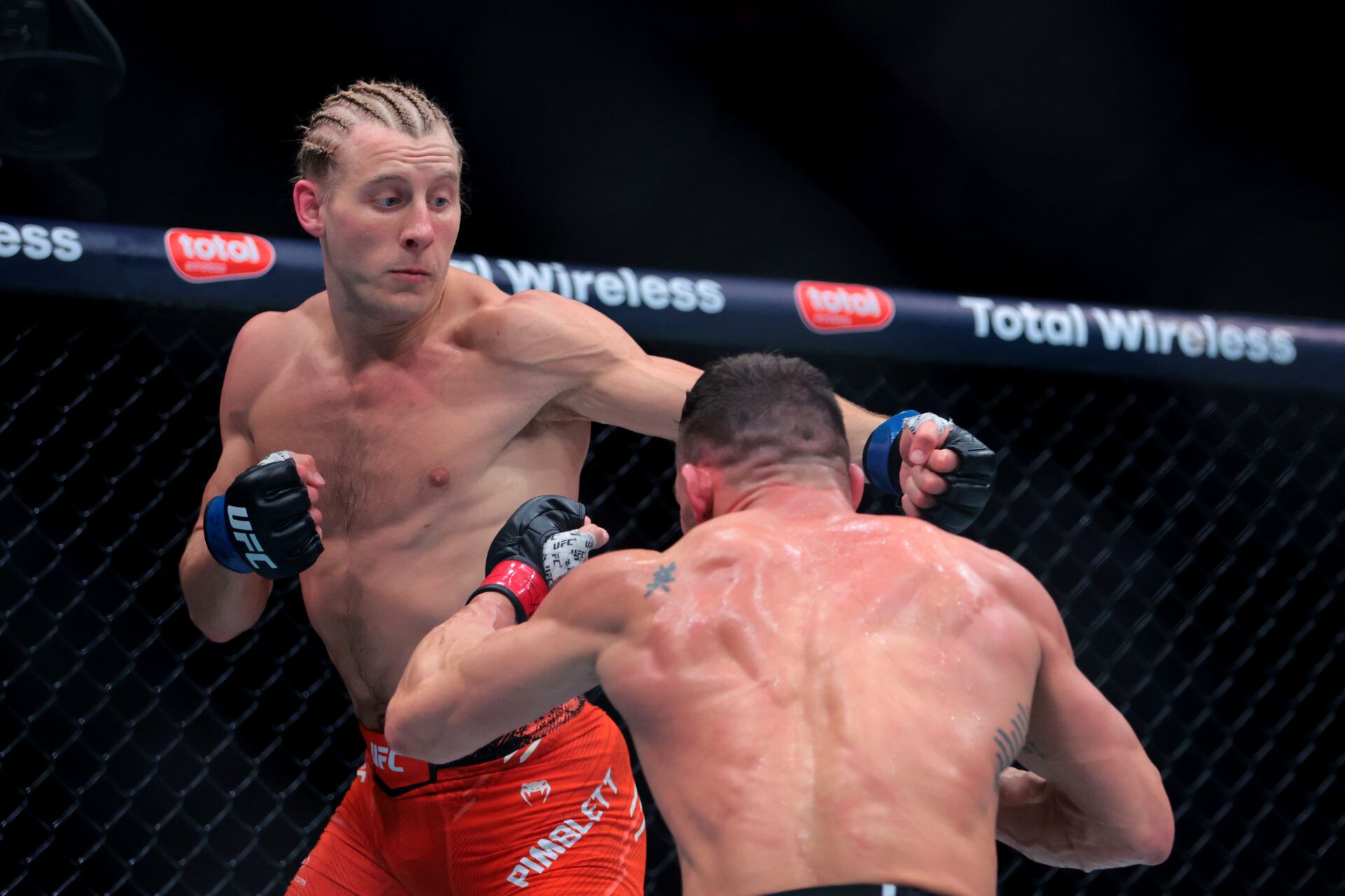 Apr 12, 2025; Miami, Florida, UNITED STATES; Michael Chandler (red gloves) fights against Paddy Pimblett (blue gloves) during UFC 314 at Kaseya Center. Mandatory Credit: Sam Navarro-Imagn Images