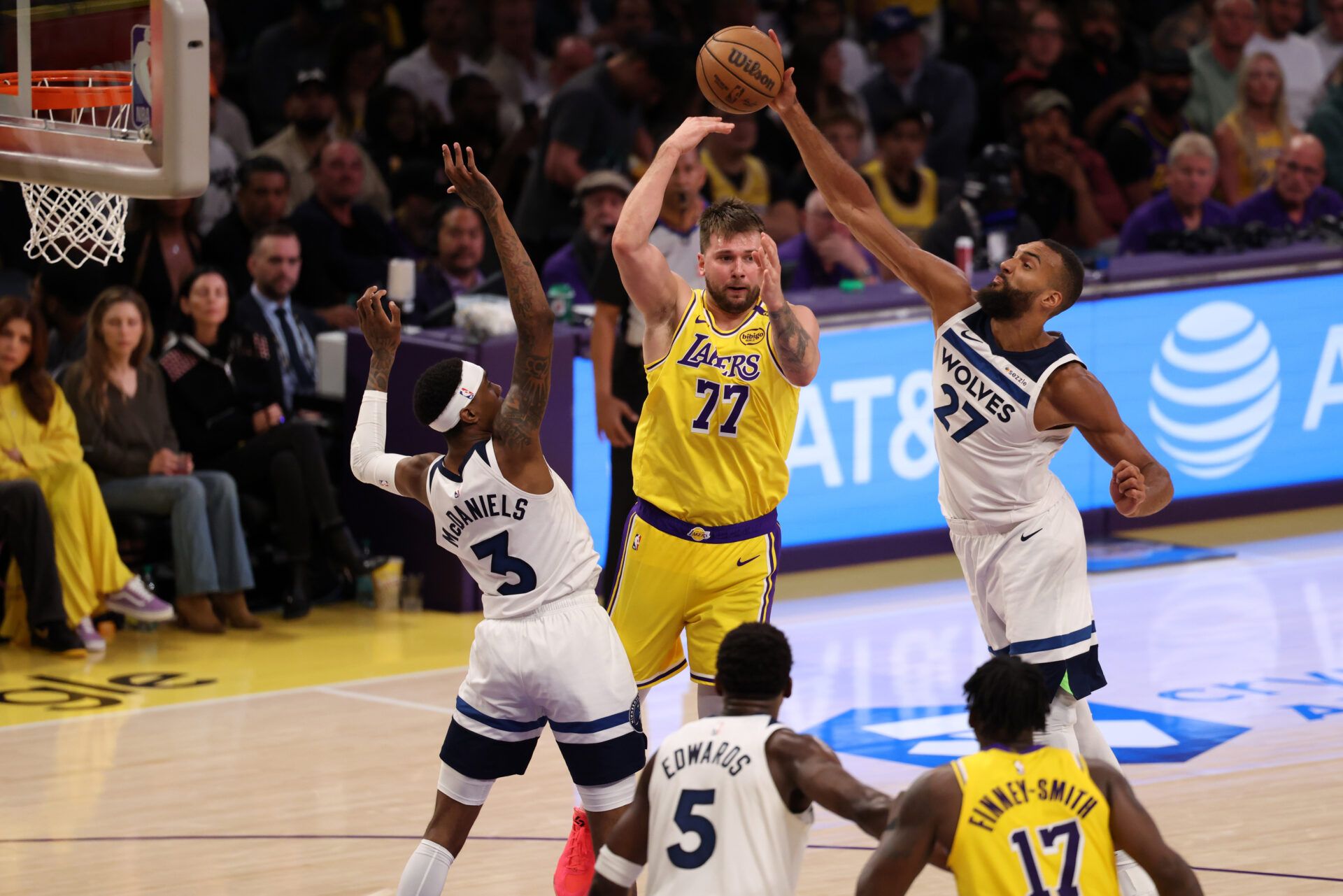 Apr 22, 2025; Los Angeles, California, USA; Los Angeles Lakers guard Luka Doncic (77) pass is deflected by Minnesota Timberwolves center Rudy Gobert (27) during the third quarter of game two of first round for the 2024 NBA Playoffs at Crypto.com Arena. Mandatory Credit: Kiyoshi Mio-Imagn Images
