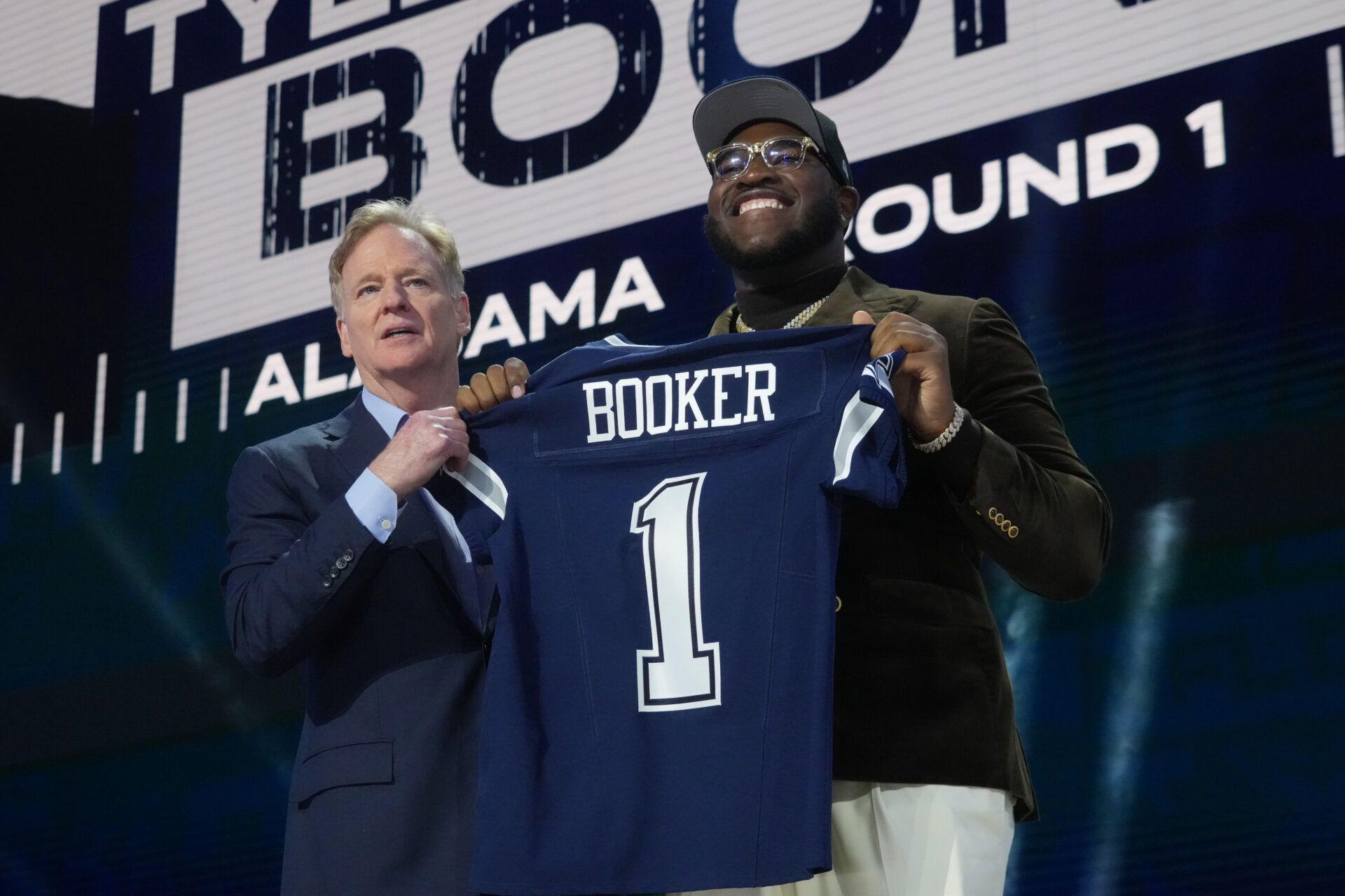 Apr 24, 2025; Green Bay, WI, USA; NFL commissioner Roger Goodell with Alabama Crimson Tide offensive lineman Tyler Booker after he is selected by the Dallas Cowboys as the number twelve pick in the first round of the 2025 NFL Draft at Lambeau Field. Mandatory Credit: Kirby Lee-Imagn Images