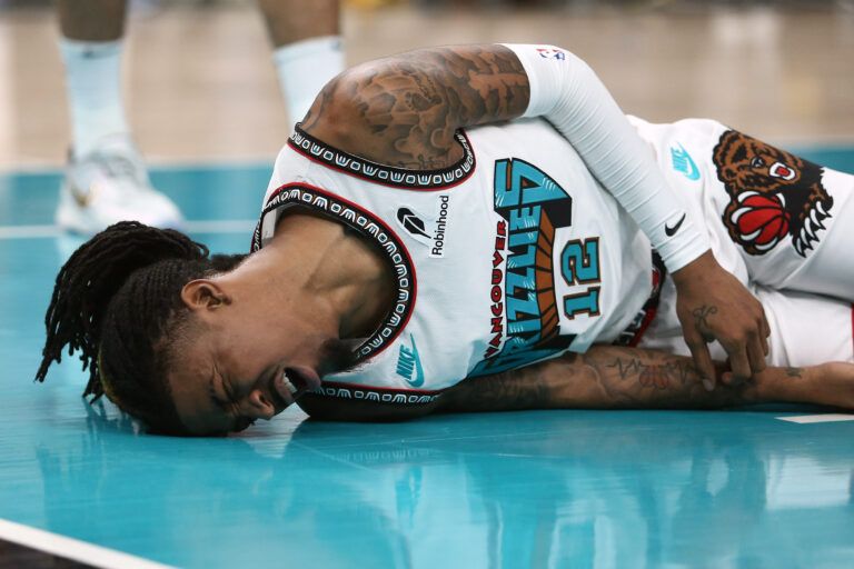 Apr 24, 2025; Memphis, Tennessee, USA; Memphis Grizzlies guard Ja Morant (12) lays on the court after being fouled during the second quarter against the Oklahoma City Thunder during game three for the first round of the 2024 NBA Playoffs at FedExForum. Mandatory Credit: Petre Thomas-Imagn Images