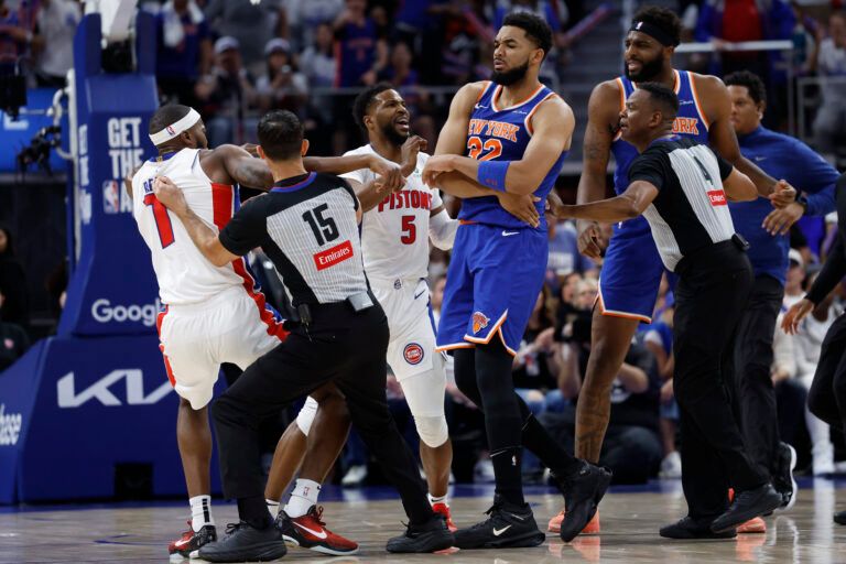 Apr 24, 2025; Detroit, Michigan, USA; Referee Zach Zarba (15) gets between Detroit Pistons forward Paul Reed (7) and New York Knicks center Karl-Anthony Towns (32) in the first half during game three of first round for the 2024 NBA Playoffs at Little Caesars Arena. Mandatory Credit: Rick Osentoski-Imagn Images