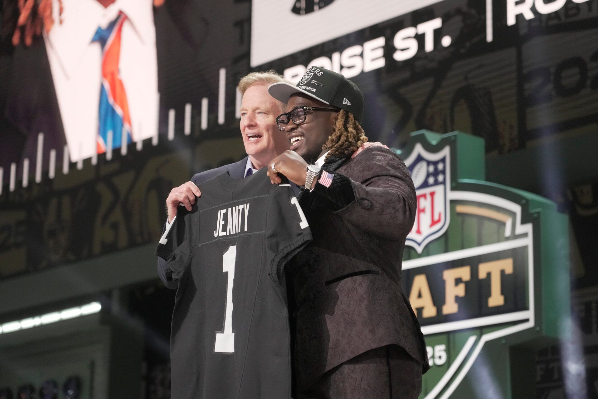 NFL Commissioner Rodger Goodell, left, with Boise State Broncos running back Ashton Jeanty is selected by the Las Vegas Raiders as the number six pick in the first round of the 2025 NFL Draft at Lambeau Field. Mark Hoffman / Milwaukee Journal Sentinel