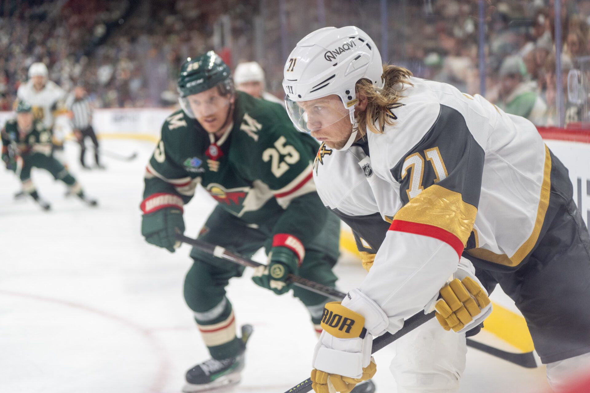 Apr 24, 2025; Saint Paul, Minnesota, USA; Vegas Golden Knights center Brett Howden (21) plays the puck in the corner as Minnesota Wild defenseman Jonas Brodin (25) defends on the play in the third period in game three of the first round of the 2025 Stanley Cup Playoffs at Xcel Energy Center. Mandatory Credit: Matt Blewett-Imagn Images