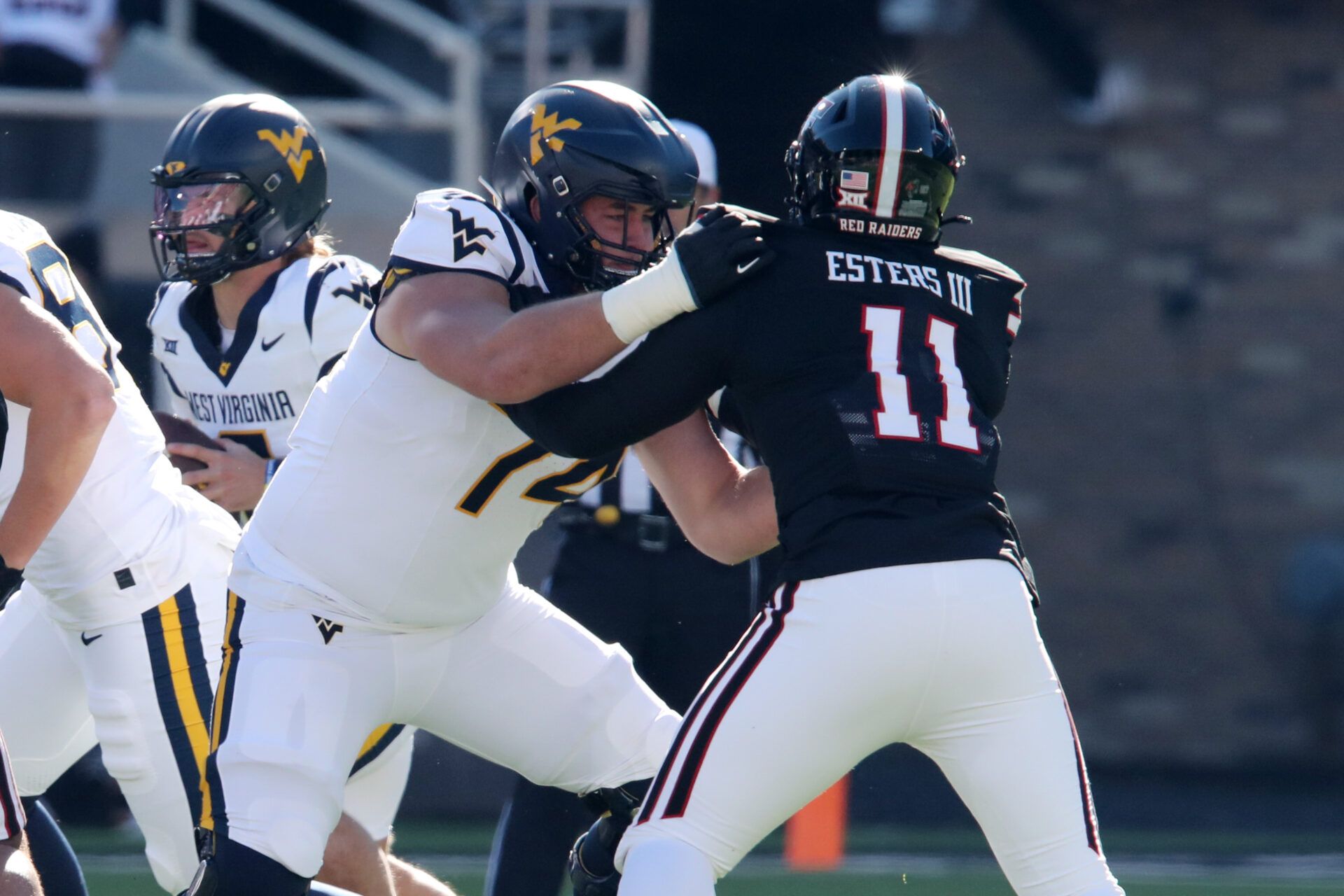 Nov 30, 2024; Lubbock, Texas, USA; West Virginia Mountaineers offensive lineman Wyatt Milum (74) blocks Texas Tech Red Raiders defensive back Charles Esters III (11) in the first half at Jones AT&T Stadium and Cody Campbell Field. Mandatory Credit: Michael C. Johnson-Imagn Images