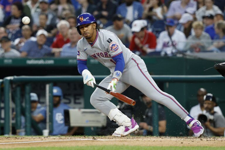 New York Mets shortstop Francisco Lindor (12) attempts a bunt against the Washington Nationals during the third inning at Nationals Park.