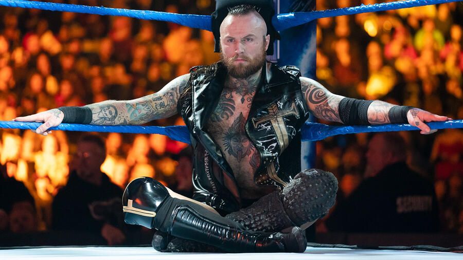 Aleister Black with his signature pose in the middle of the ring on WWE SmackDown