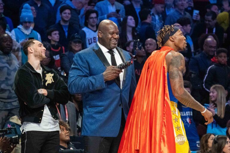 February 15, 2020; Chicago, Illinois, USA; Chicago Bulls player Zach LaVine (left) watches NBA great Shaquille O'Neal (center) videotape Los Angeles Lakers player Dwight Howard (right) in a Superman costume dedicated to the late Los Angeles Lakers great Kobe Bryant during NBA All Star Saturday Night at United Center. Mandatory Credit: Kyle Terada-USA TODAY Sports