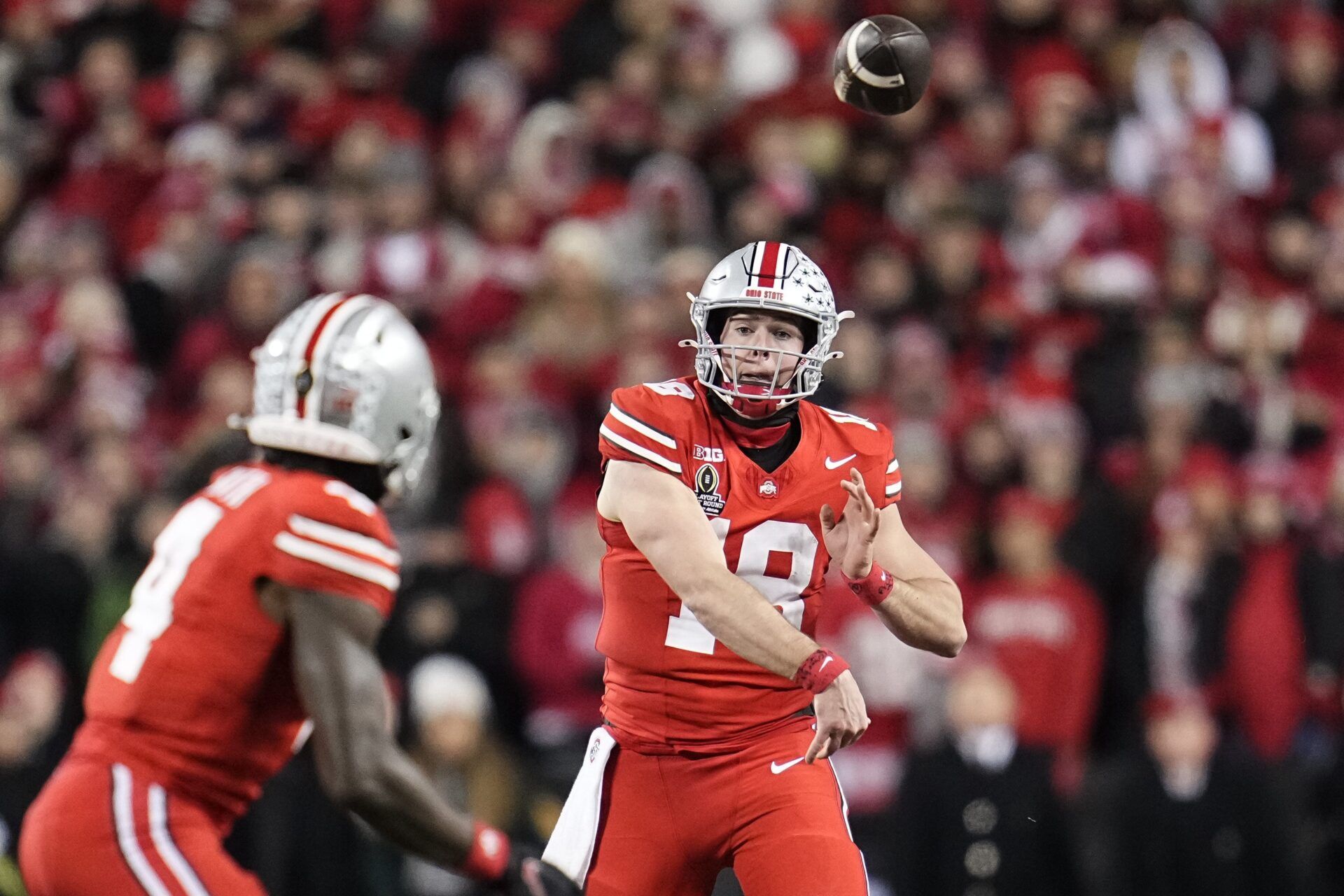 Ohio State Buckeyes quarterback Will Howard (18) throws to wide receiver Jeremiah Smith (4) during the first half of the College Football Playoff first round game against the Tennessee Volunteers at Ohio Stadium in Columbus on Dec. 21, 2024.