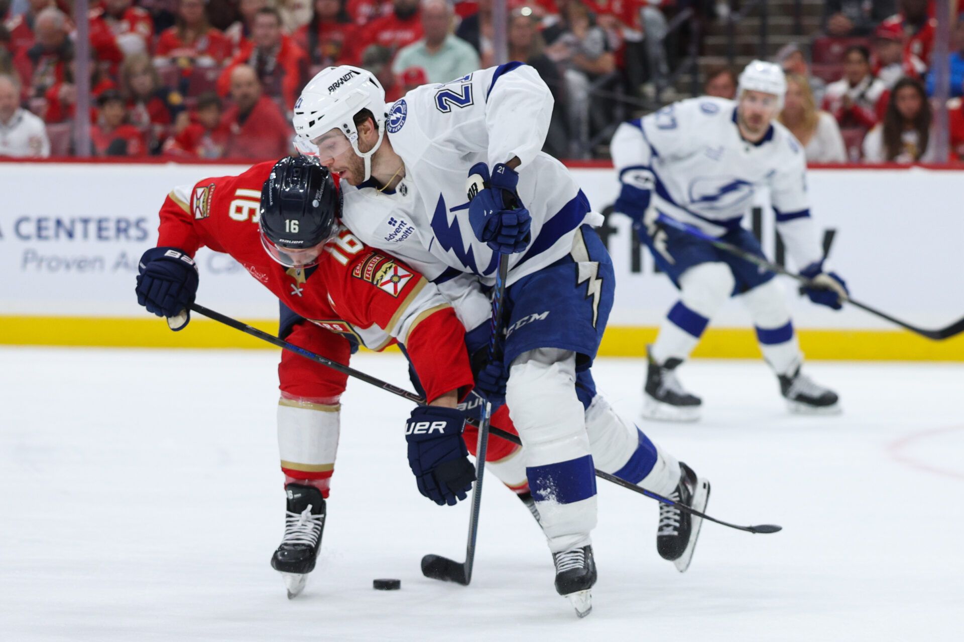 Apr 26, 2025; Sunrise, Florida, USA; Florida Panthers center Aleksander Barkov (16) and Tampa Bay Lightning center Brayden Point (21) battle for the puck in the second period during game three of the first round of the 2025 Stanley Cup Playoffs at Amerant Bank Arena. Mandatory Credit: Nathan Ray Seebeck-Imagn Images