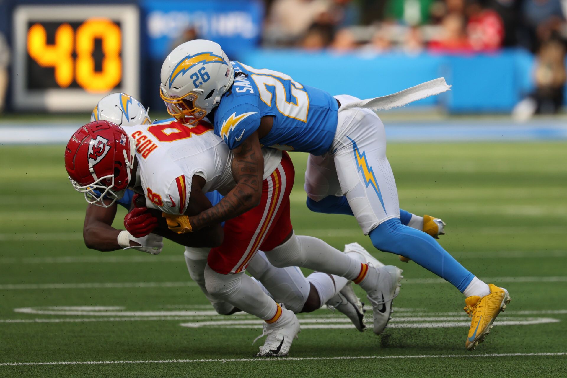 Kansas City Chiefs wide receiver Justyn Ross (8) is tackled by Los Angeles Chargers cornerback Asante Samuel Jr. (26) during the first quarter at SoFi Stadium.