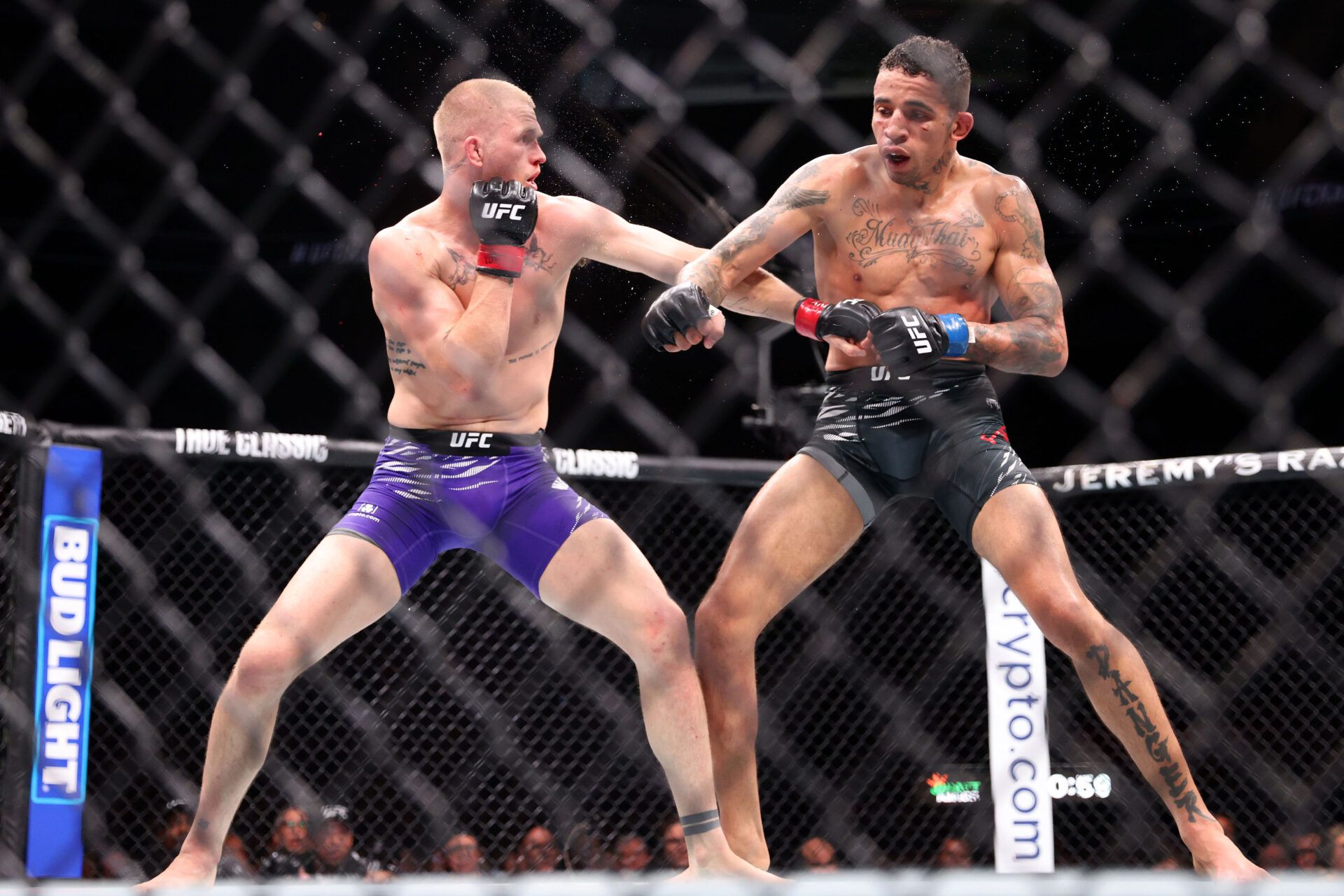 Apr 26, 2025; Kansas City, Missouri, UNITED STATES; Ian Machado Garry (red gloves) fights Carlos Prates (blue gloves) during UFC Fight Night at T-Mobile Center. Mandatory Credit: William Purnell-Imagn Images