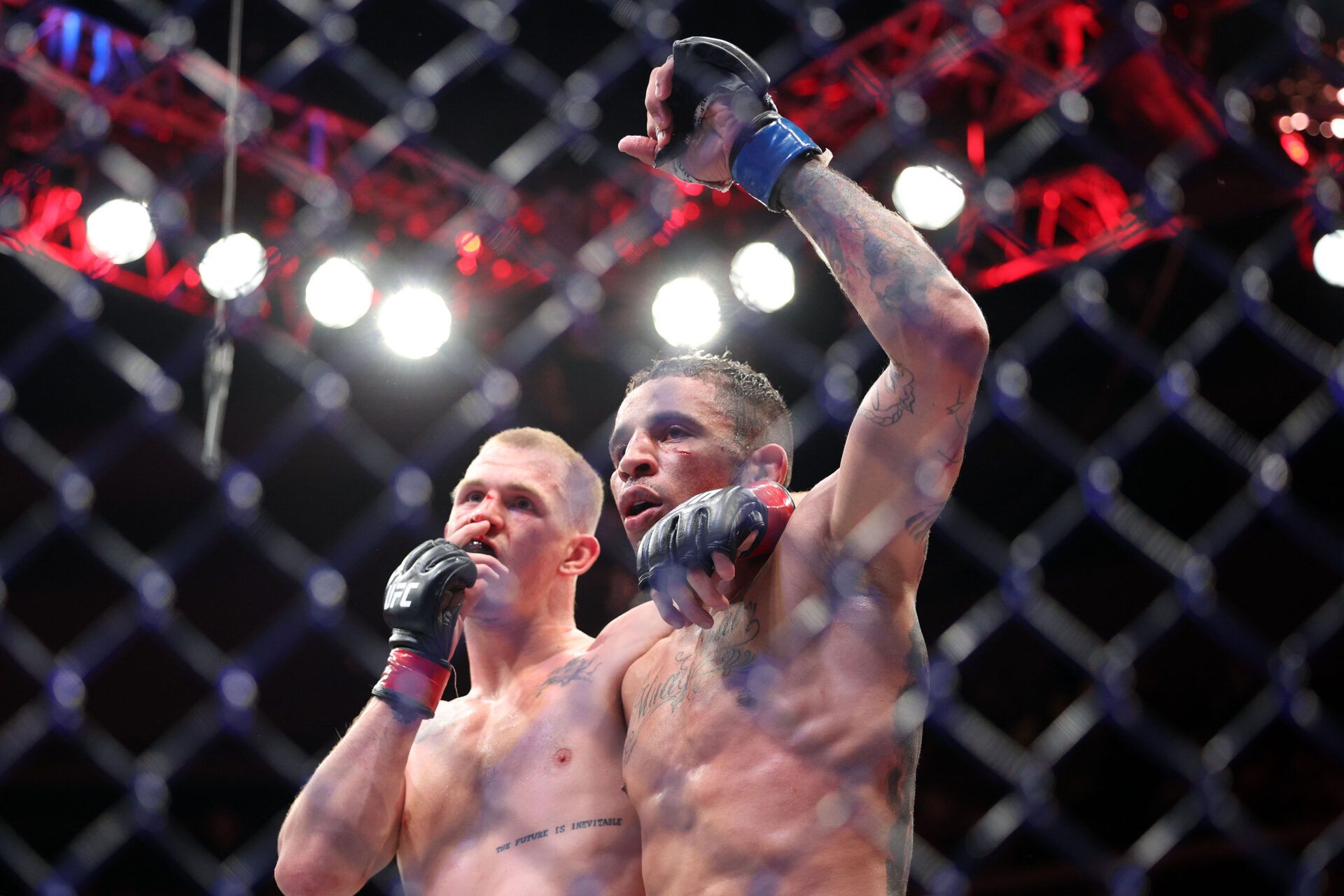 Apr 26, 2025; Kansas City, Missouri, UNITED STATES; Ian Machado Garry (red gloves) reacts with Carlos Prates (blue gloves) after the fight during UFC Fight Night at T-Mobile Center. Mandatory Credit: William Purnell-Imagn Images