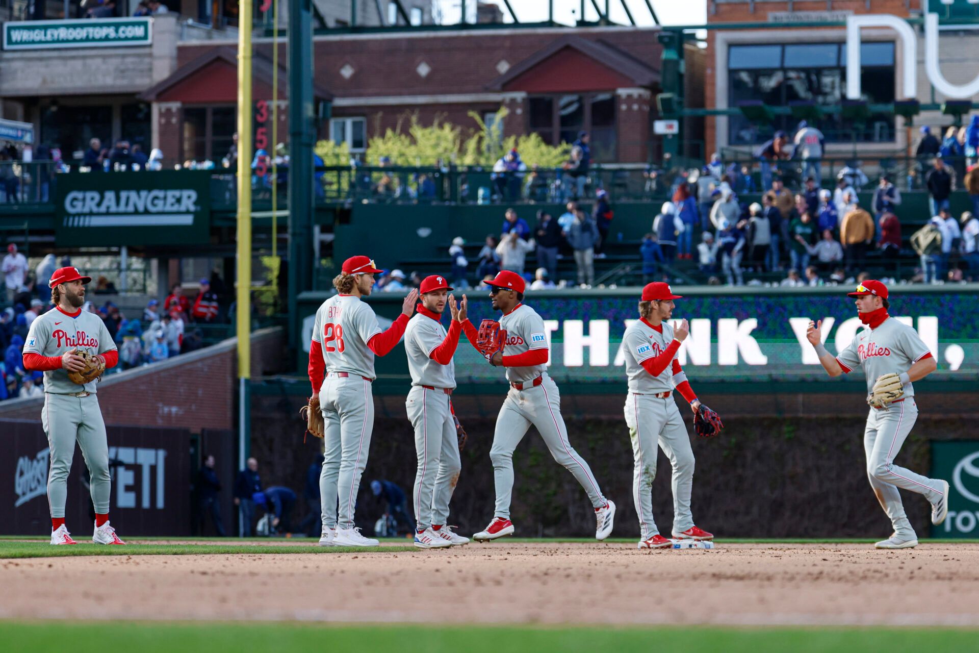 Apr 26, 2025; Chicago, Illinois, USA; Philadelphia Phillies players celebrate after defeating the Chicago Cubs in a baseball game at Wrigley Field. Mandatory Credit: Kamil Krzaczynski-Imagn Images