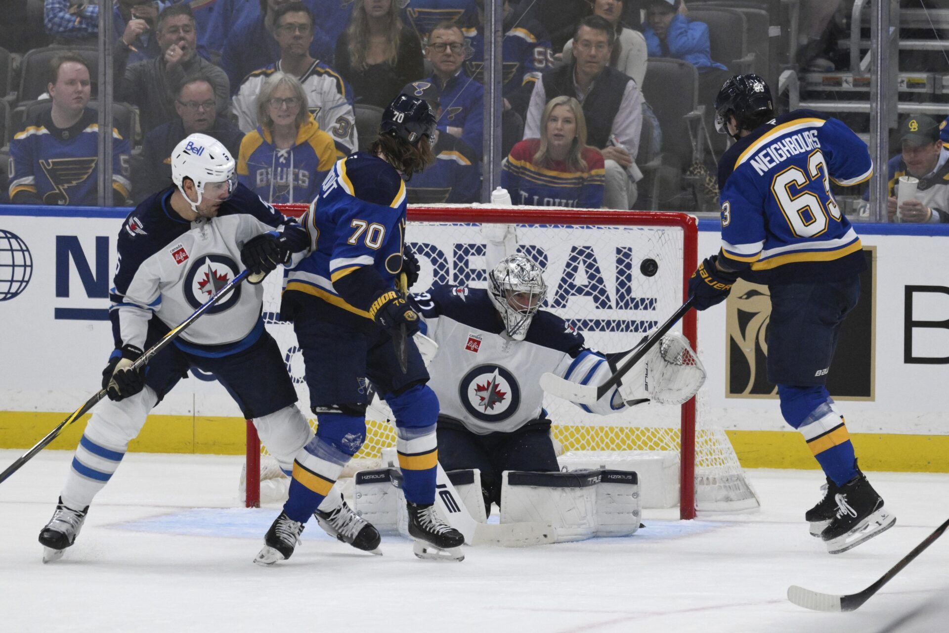 Winnipeg Jets goaltender Connor Hellebuyck (37) gives up a goal to St. Louis Blues left wing Jake Neighbours (63) during the first period in game four of the first round of the 2025 Stanley Cup Playoffs at Enterprise Center.