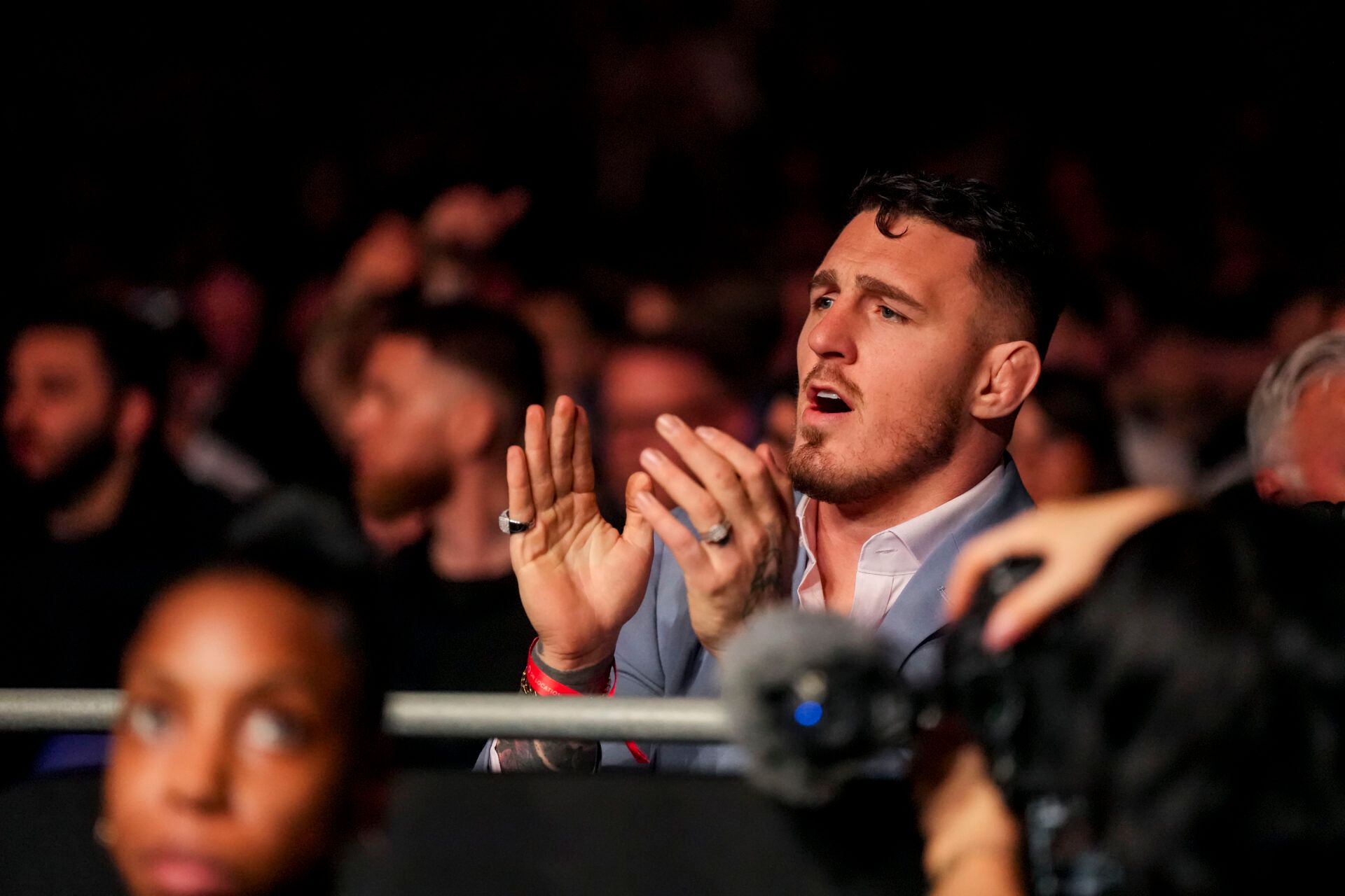 Mar 22, 2025; London, England, United Kingdom; Tom Aspinall, UFC Heavyweight fighter, watches as Marcin Tybura (red gloves) fights against Mick Parkin (blue gloves) during UFC Fight Night at O2 Arena. Mandatory Credit: Peter van den Berg-Imagn Images