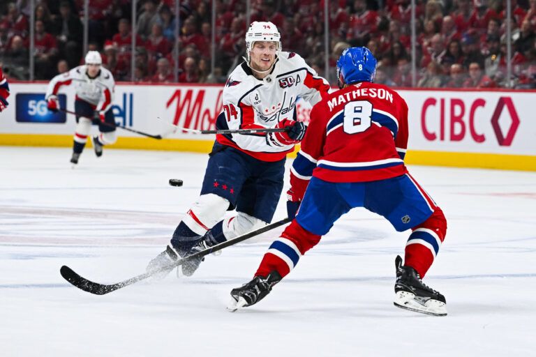 Apr 27, 2025; Montreal, Quebec, CAN; Washington Capitals defenseman John Carlson (74) shoots the puck beside Montreal Canadiens defenseman Mike Matheson (8) during the second period in game four of the first round of the 2025 Stanley Cup Playoffs at Bell Centre. Mandatory Credit: David Kirouac-Imagn Images