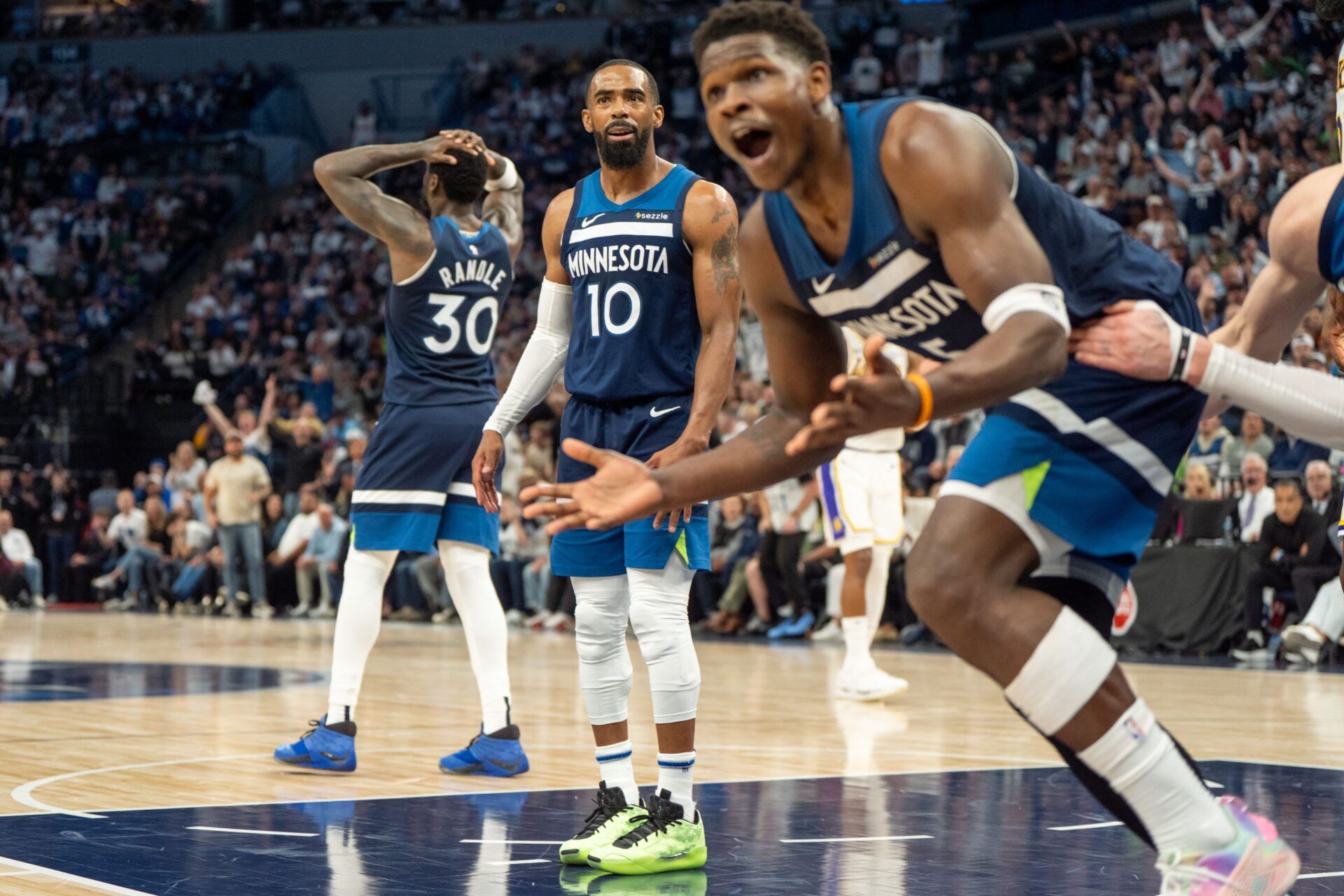 Apr 27, 2025; Minneapolis, Minnesota, USA; Minnesota Timberwolves guard Mike Conley (10) and guard Anthony Edwards (5) argue a foul against the Los Angeles Lakers in the second quarter during game four of first round for the 2025 NBA Playoffs at Target Center. Mandatory Credit: Matt Blewett-Imagn Images