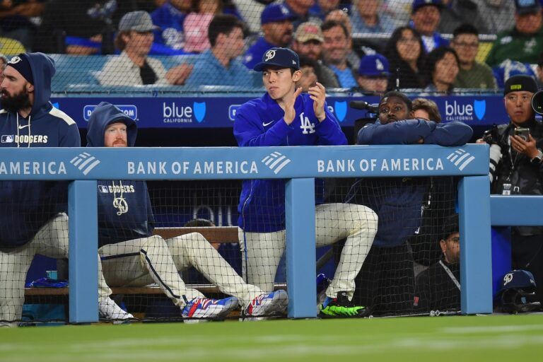 Los Angeles Dodgers pitcher Roki Sasaki (11) watches game action against the Pittsburgh Pirates during the eighth inning at Dodger Stadium.