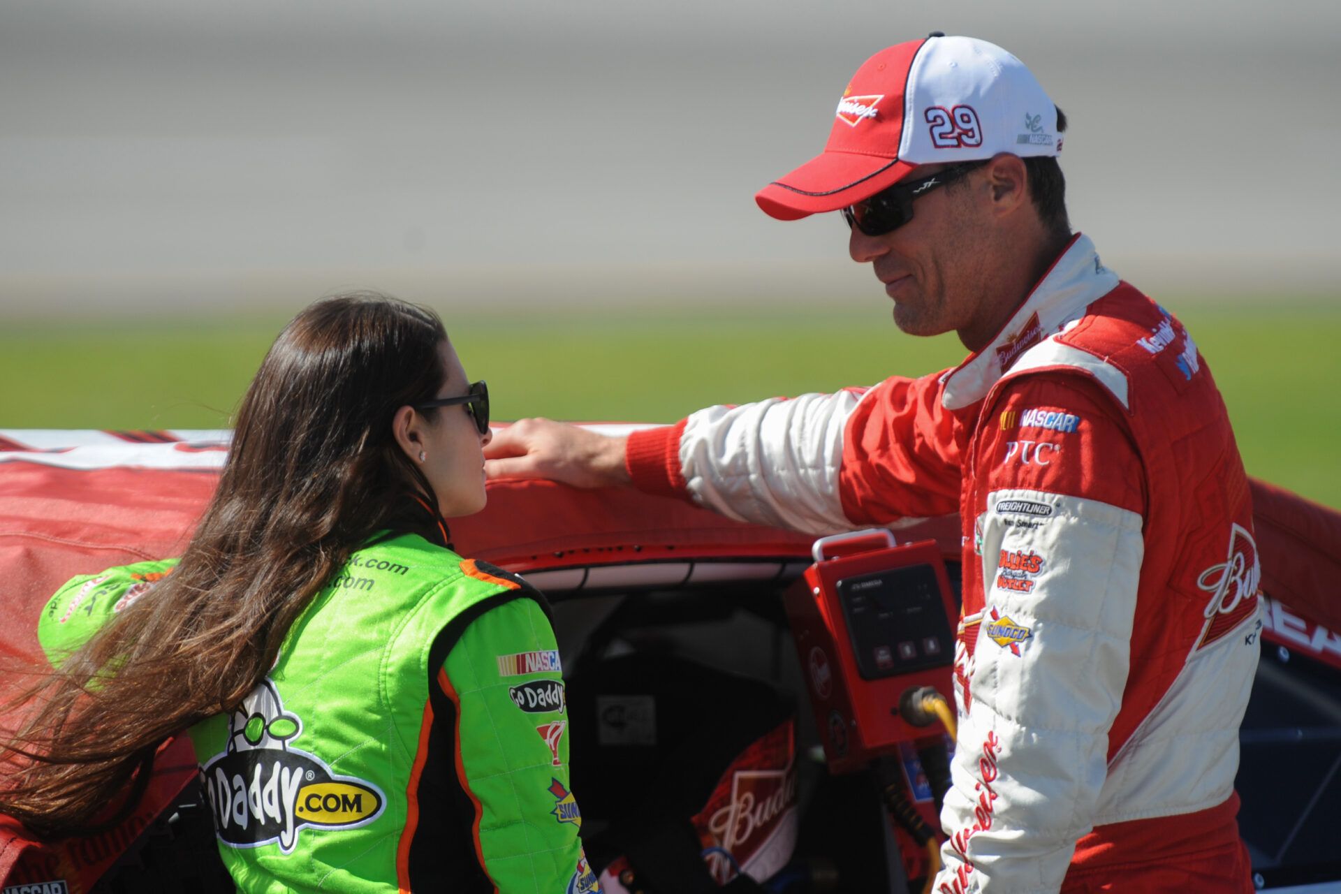 Jun 28, 2013; Sparta, KY, USA; NASCAR Sprint Cup Series driver Danica Patrick (10) and Kevin Harvick (29) talk during qualifying for the Quaker State 400 at Kentucky Speedway. Mandatory Credit: Randy Sartin-USA TODAY Sports