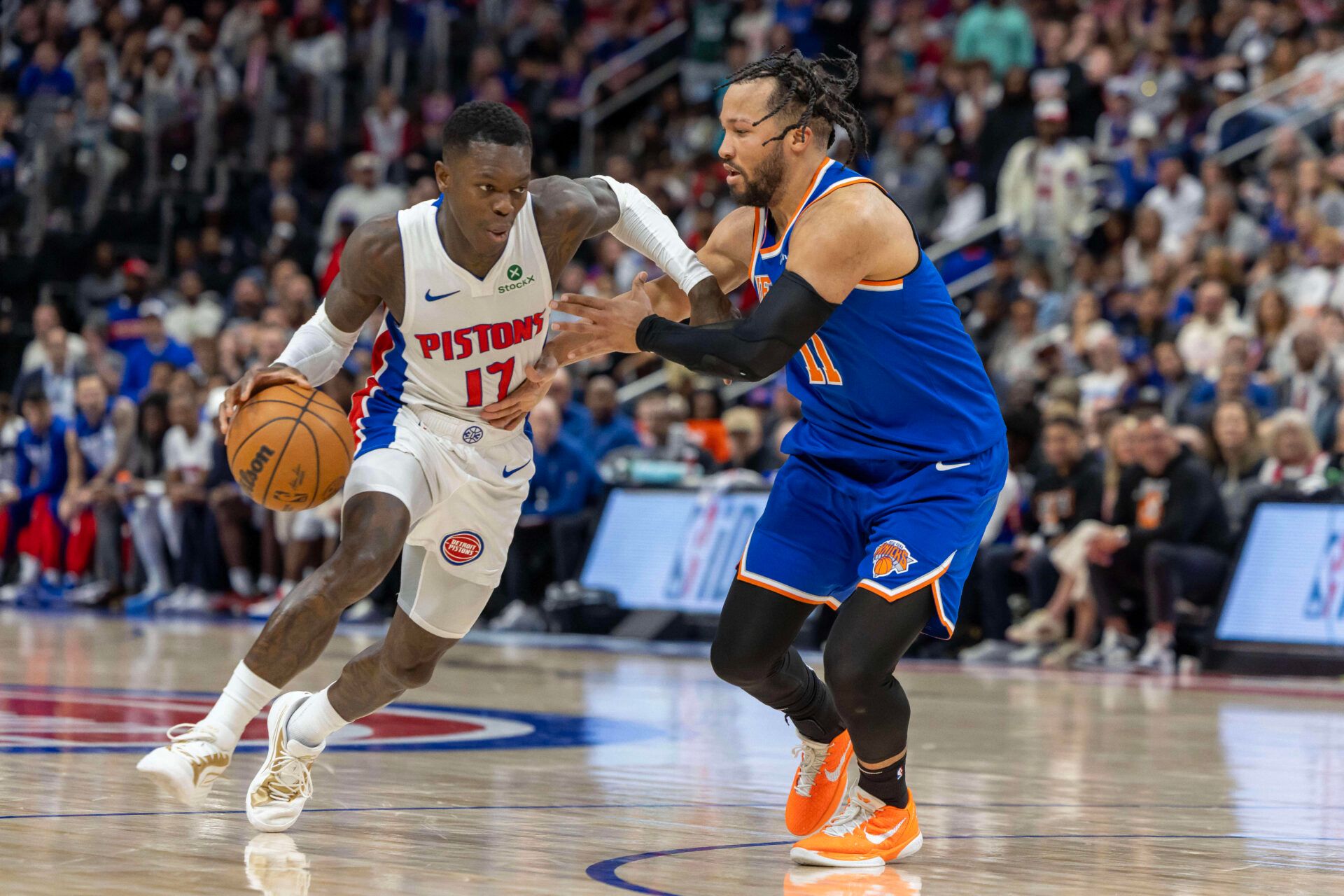 Apr 27, 2025; Detroit, Michigan, USA; New York Knicks guard Jalen Brunson (11) defends against Detroit Pistons guard Dennis Schroder (17) during the fourth quarter of game four of first round for the 2025 NBA Playoffs at Little Caesars Arena. Mandatory Credit: David Reginek-Imagn Images