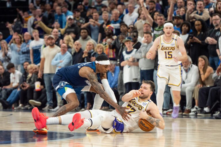 Apr 27, 2025; Minneapolis, Minnesota, USA; Los Angeles Lakers guard Luka Doncic (77) calls a timeout after stumbling on the defense of Minnesota Timberwolves forward Jaden McDaniels (3) in the fourth quarter during game four of first round for the 2025 NBA Playoffs at Target Center. Mandatory Credit: Matt Blewett-Imagn Images