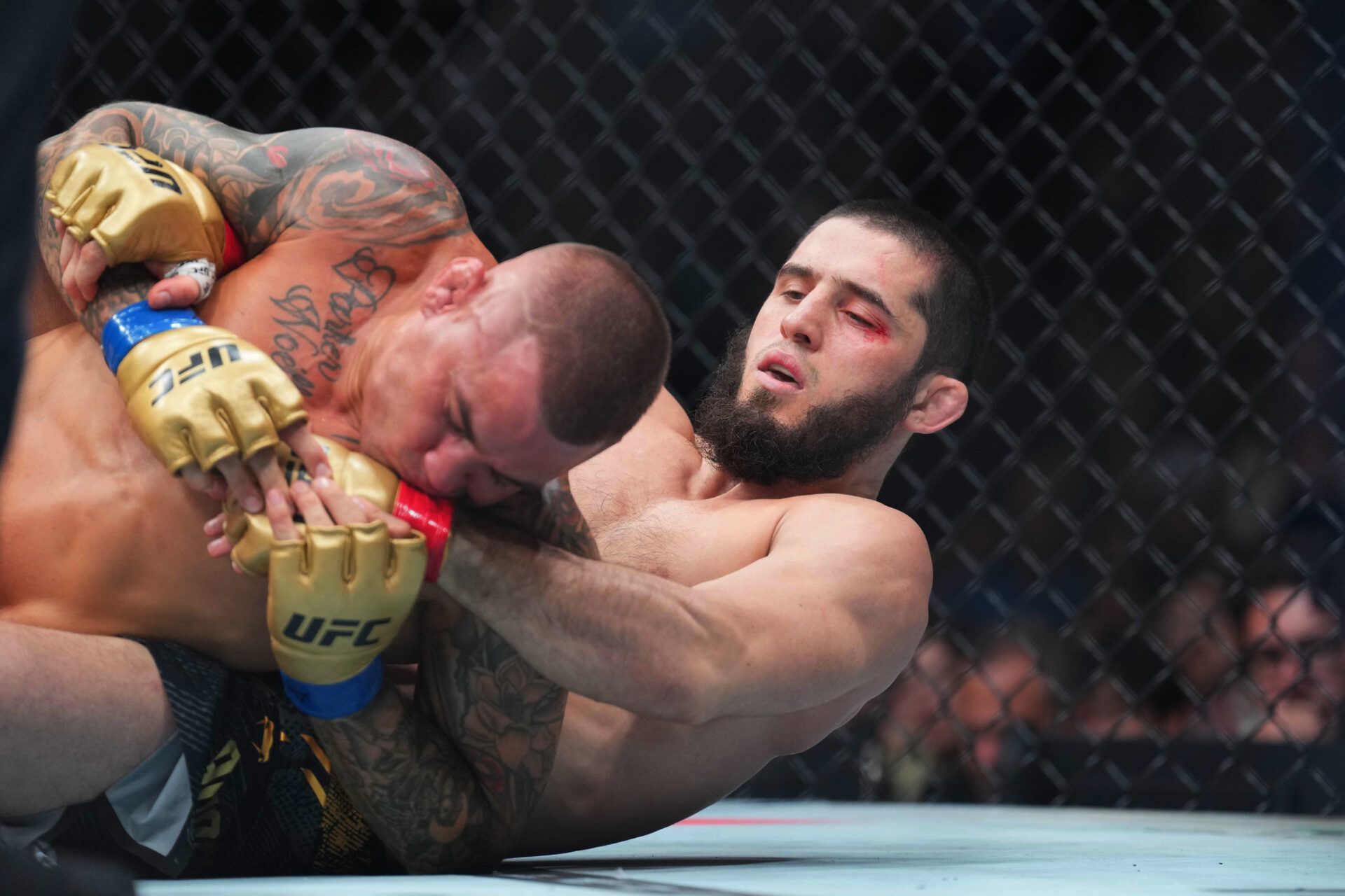 Jun 1, 2024; Newark, New Jersey, USA; Islam Makhachev (red gloves) fights Dustin Poirier (blue gloves) during UFC 302 at Prudential Center. Mandatory Credit: Joe Camporeale-USA TODAY Sports