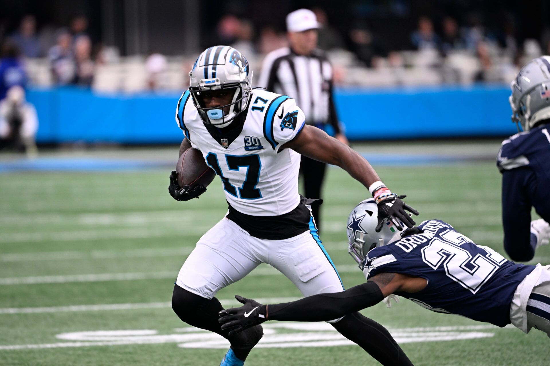 Dec 15, 2024; Charlotte, North Carolina, USA; Carolina Panthers wide receiver Xavier Legette (17) with the ball as Dallas Cowboys cornerback Amani Oruwariye (27) defefends in the first quarter at Bank of America Stadium. Mandatory Credit: Bob Donnan-Imagn Images
