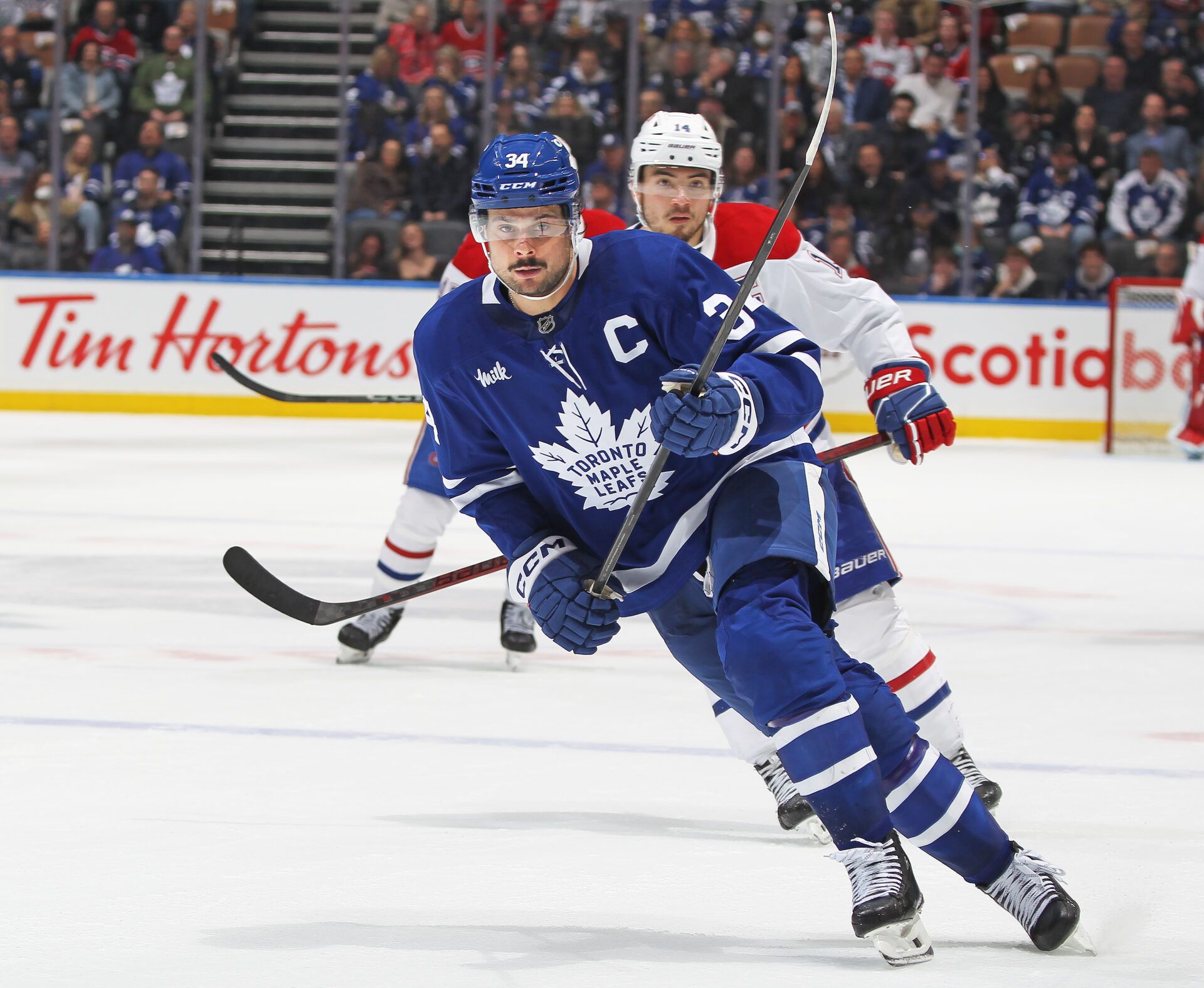 TORONTO, CANADA - APRIL 12: Auston Matthews #34 of the Toronto Maple Leafs skates against nick Suzuki #14 of the Montreal Canadiens during the third period of an NHL game at Scotiabank Arena on April 12, 2025 in Toronto, Ontario, Canada. The Maple Leafs defeated the Canadiens 1-0 in overtime. (Photo by Claus Andersen/Getty Images)