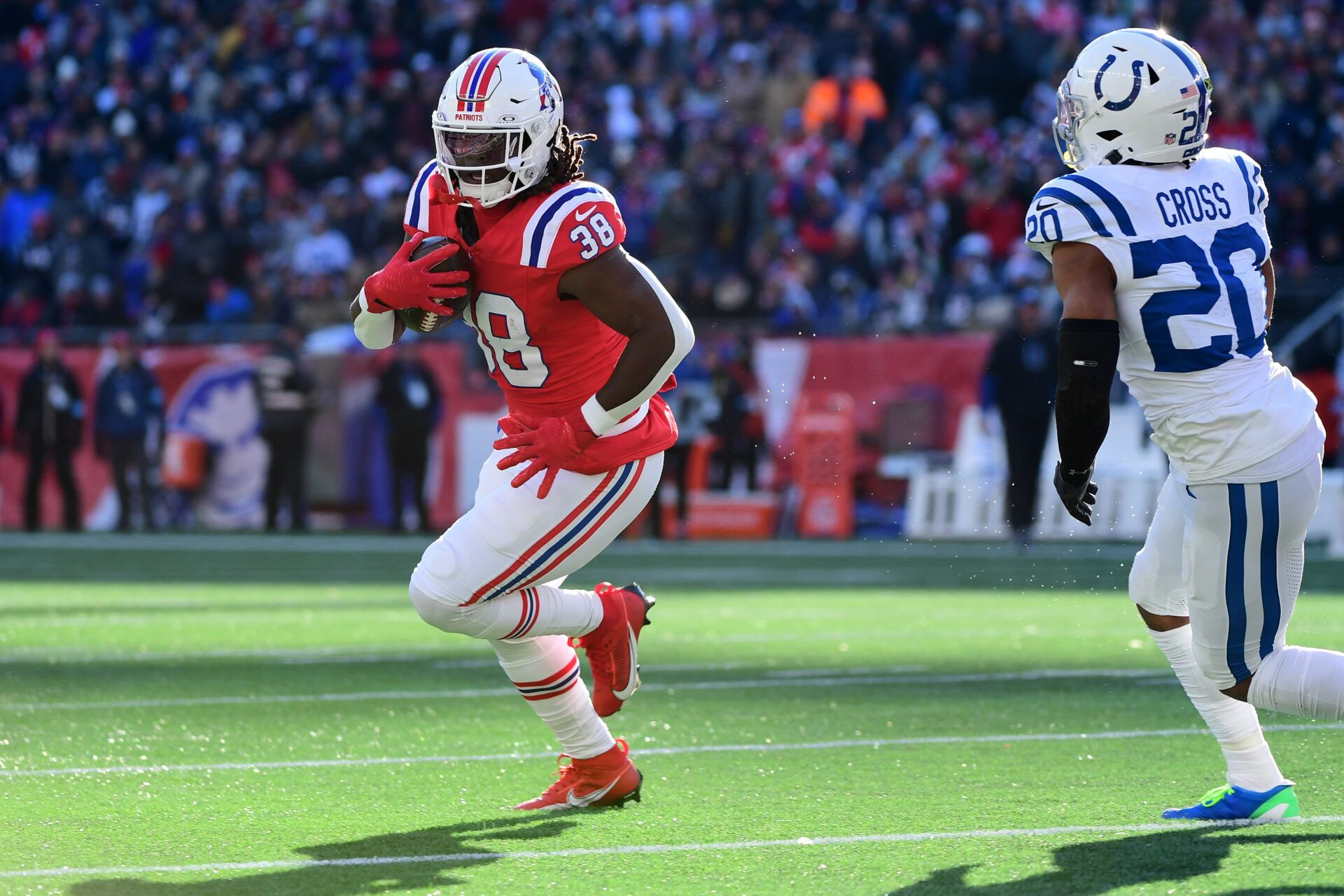 Dec 1, 2024; Foxborough, Massachusetts, USA; New England Patriots running back Rhamondre Stevenson (38) runs the ball while Indianapolis Colts safety Nick Cross (20) defends during the first half at Gillette Stadium. Mandatory Credit: Bob DeChiara-Imagn Images