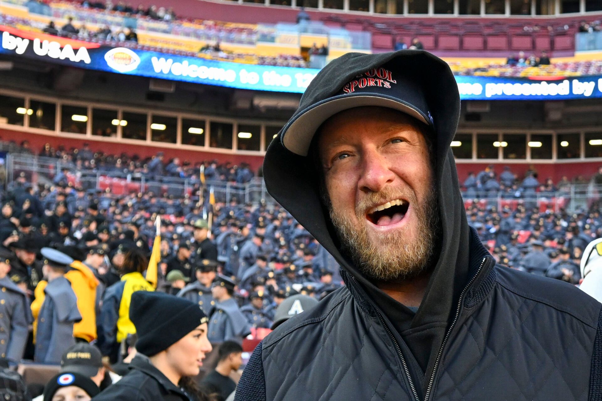 Dec 14, 2024; Landover, Maryland, USA; Dave Portnoy, Bar Stool Sports founder and owner walks along the sidelines before the playing of the 125 Army Navy game at Commanders Field. Mandatory Credit: Tommy Gilligan-Imagn Images Dec 14, 2024; Landover, Maryland, USA; Dave Portnoy poses with solders before the between the Army Black Knights and the Navy Midshipmen at Commanders Field. Mandatory Credit: Tommy Gilligan-Imagn Images