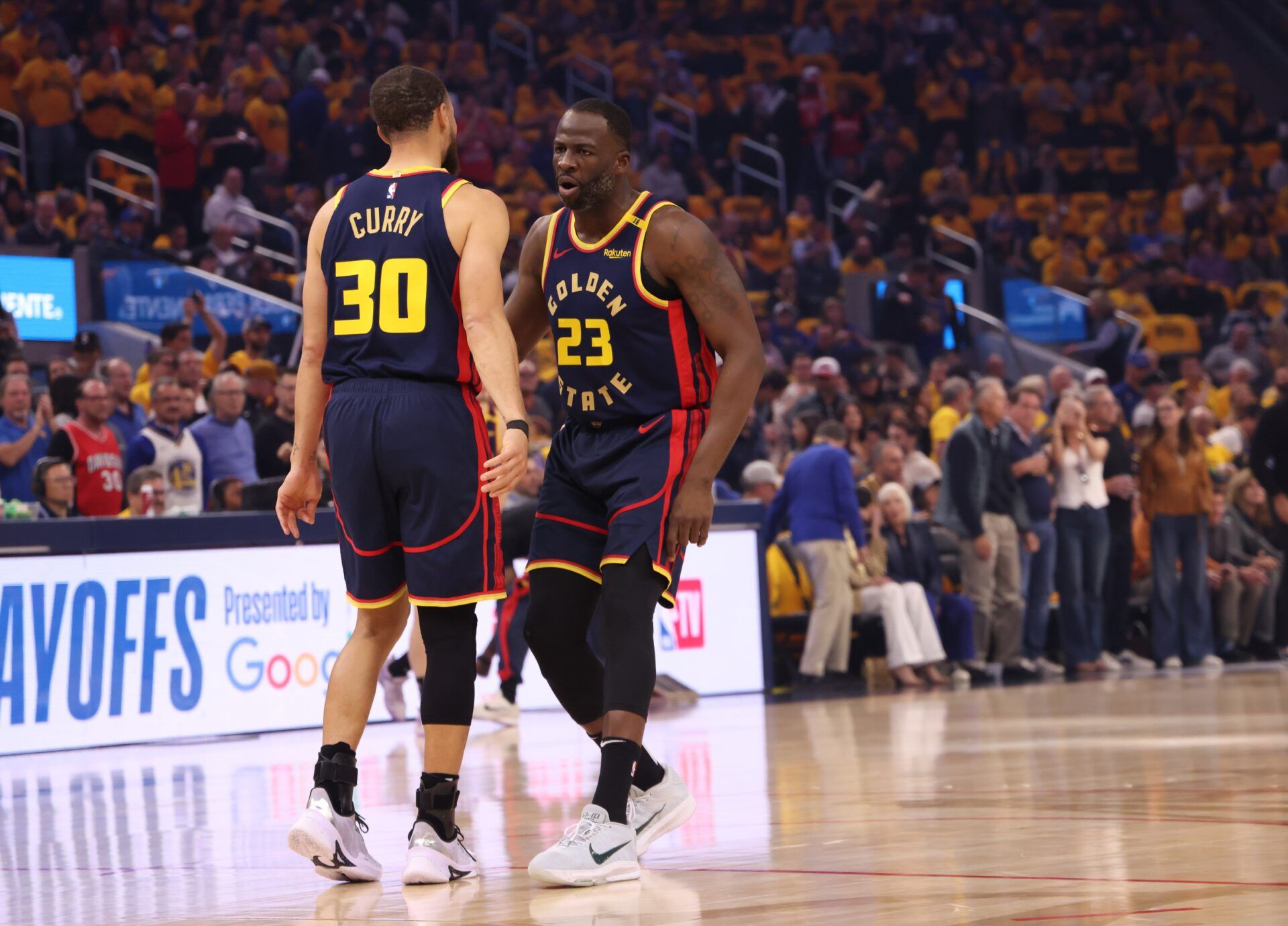 Apr 28, 2025; San Francisco, California, USA; Golden State Warriors forward Draymond Green (23) celebrated sight guard Stephen Curry (30) after a play against the Houston Rockets during the first quarter of game four of the 2025 NBA Playoffs first round at Chase Center. Mandatory Credit: Kelley L Cox-Imagn Images