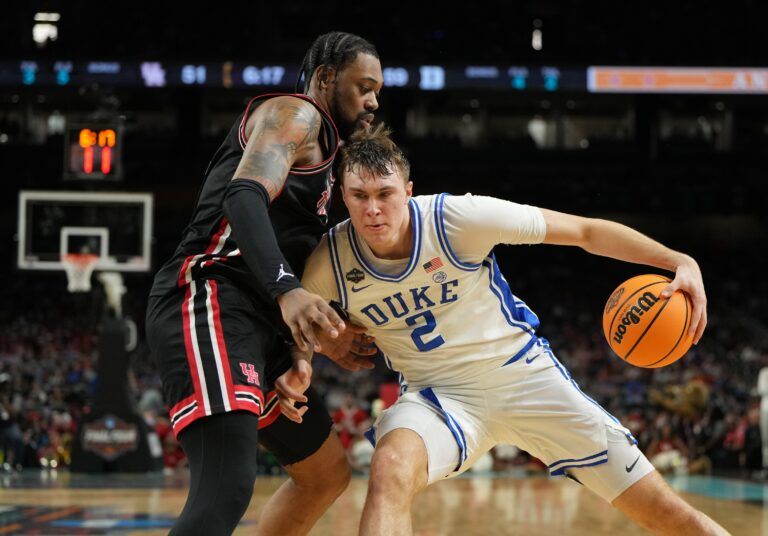 Apr 5, 2025; San Antonio, TX, USA; Duke Blue Devils forward Cooper Flagg (2) controls the ball against Houston Cougars forward J'Wan Roberts (13) during the second half in the semifinals of the men's Final Four of the 2025 NCAA Tournament at the Alamodome. Mandatory Credit: Bob Donnan-Imagn Images