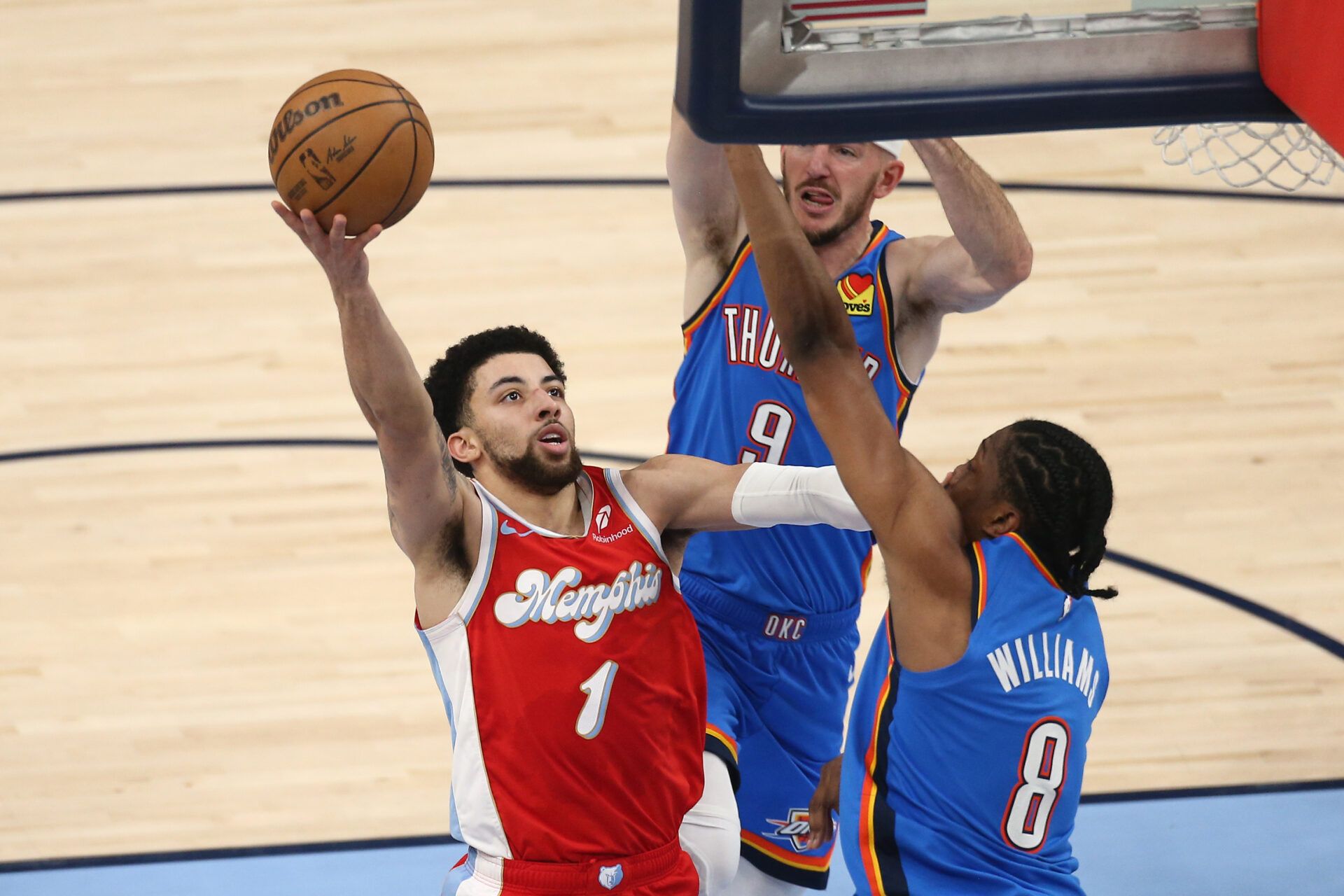 Apr 26, 2025; Memphis, Tennessee, USA; Memphis Grizzlies guard Scotty Pippen Jr. (1) shoots as Oklahoma City Thunder forward Jalen Williams (8) defends during the second quarter during game four for the first round of the 2024 NBA Playoffs at FedExForum. Mandatory Credit: Petre Thomas-Imagn Images