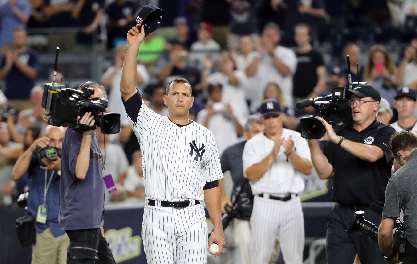 New York Yankees designated hitter Alex Rodriguez (13) tips his cap in a farewell gesture to the fans after the game against the Tampa Bay Rays at Yankee Stadium. New York Yankees won 6-3.