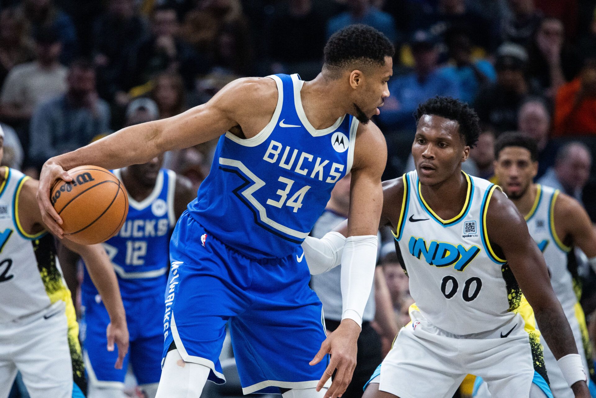 Mar 11, 2025; Indianapolis, Indiana, USA; Milwaukee Bucks forward Giannis Antetokounmpo (34) dribbles the ball while Indiana Pacers guard Bennedict Mathurin (00) defends in the first half at Gainbridge Fieldhouse. Mandatory Credit: Trevor Ruszkowski-Imagn Images