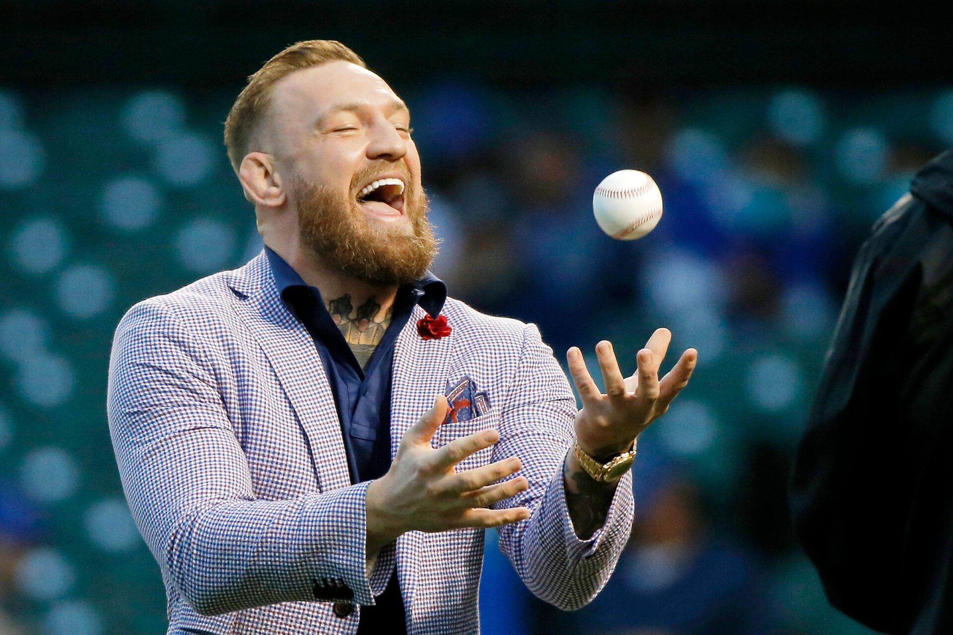Sep 21, 2021; Chicago, Illinois, USA; MMA fighter Conor McGregor tosses the ball after throwing out a ceremonial first pitch before the game between the Chicago Cubs and the Minnesota Twins at Wrigley Field. Mandatory Credit: Jon Durr-USA TODAY Sports