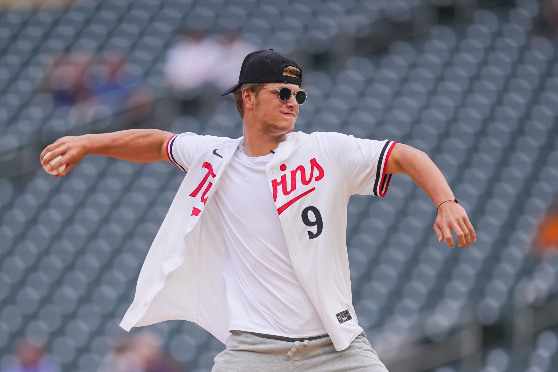 Jun 18, 2024; Minneapolis, Minnesota, USA; Minnesota Vikings first round draft pick JJ McCarthy throws out the ceremonial first pitch in a game between the Minnesota Twins and Tampa Bay Rays at Target Field. Mandatory Credit: Brad Rempel-USA TODAY Sports